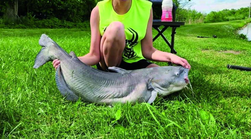 girl smiling with her large catfish