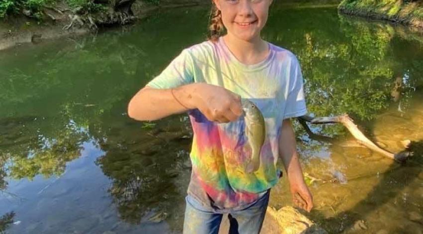 girl smiling holding fish