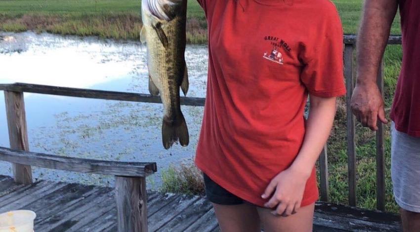 girl smiling holding fish