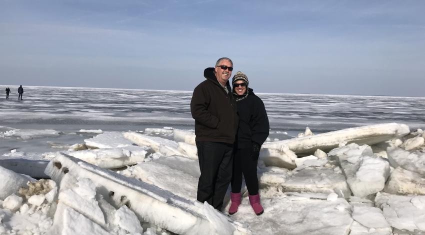 man and woman standing on ice slabs