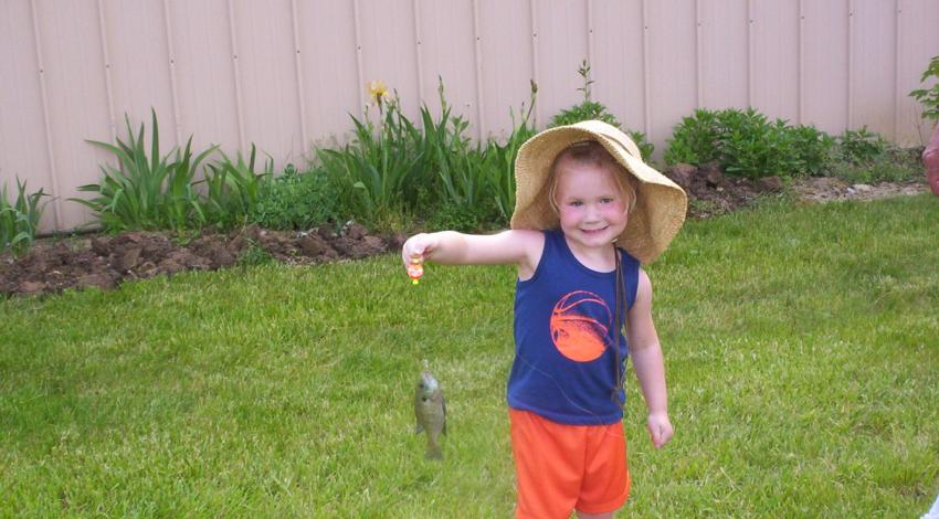 girl smiling holding a fish