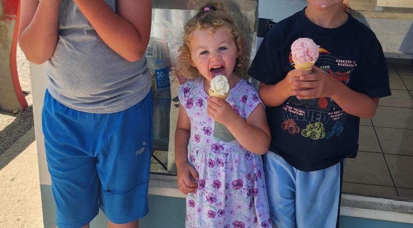 two boys and a little girl with ice cream cones