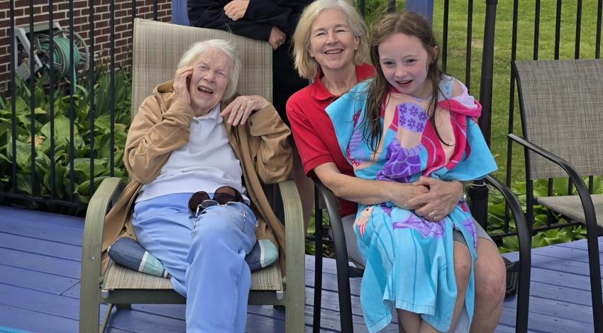 three women and a little girl on a deck