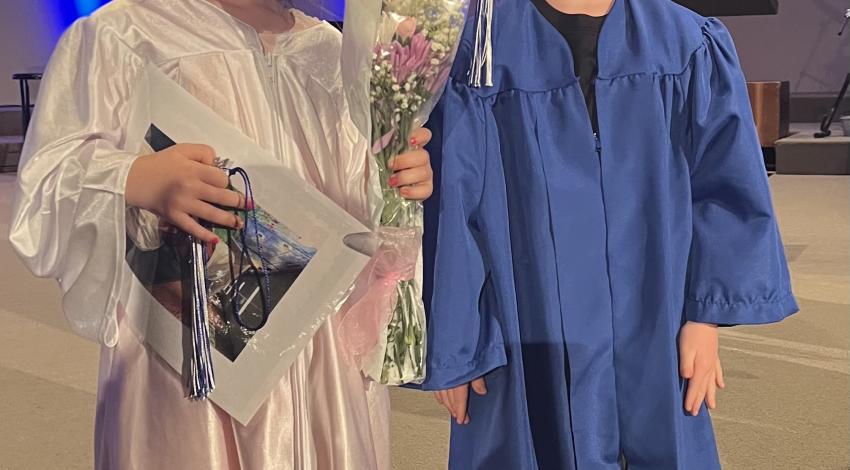 little girl and little boy in graduation gowns