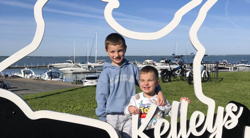 two little boys with Kelleys Island sign