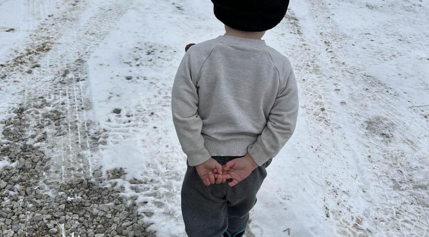 little boy walking on snow