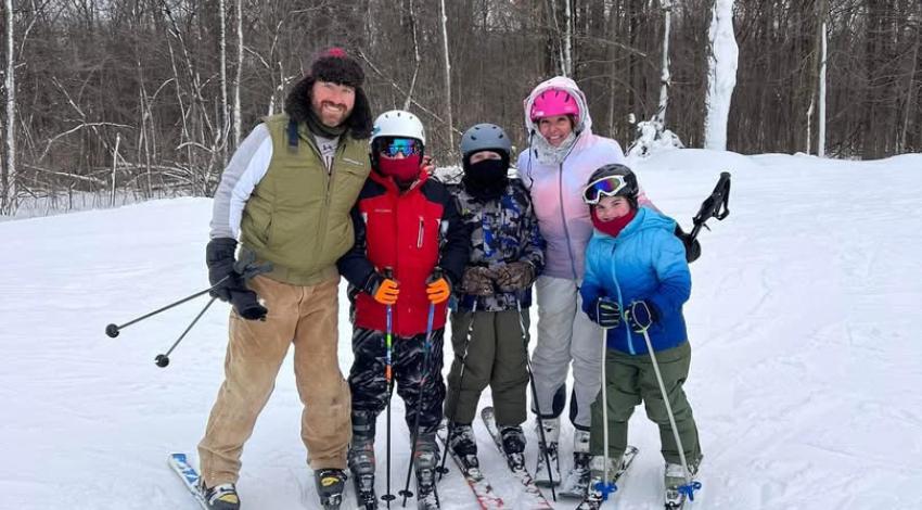adults and children on skis