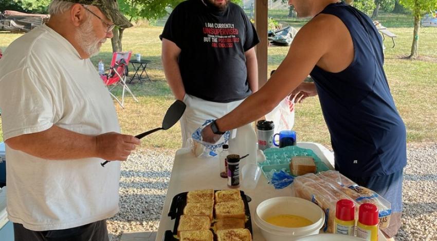 man cooking on outdoor griddle