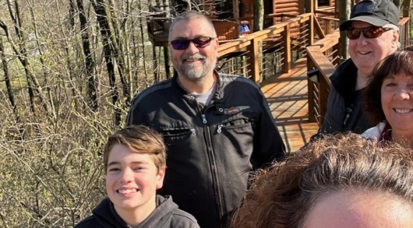 family in front of cabin in the woods
