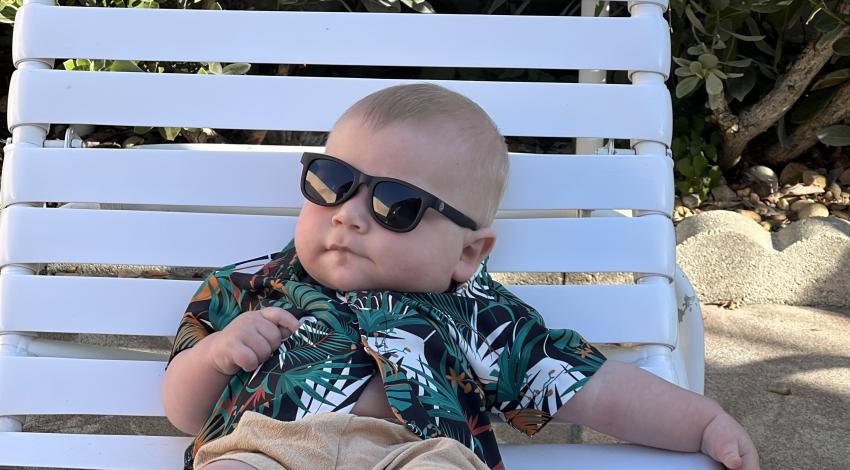 baby in sunglasses on lounge chair