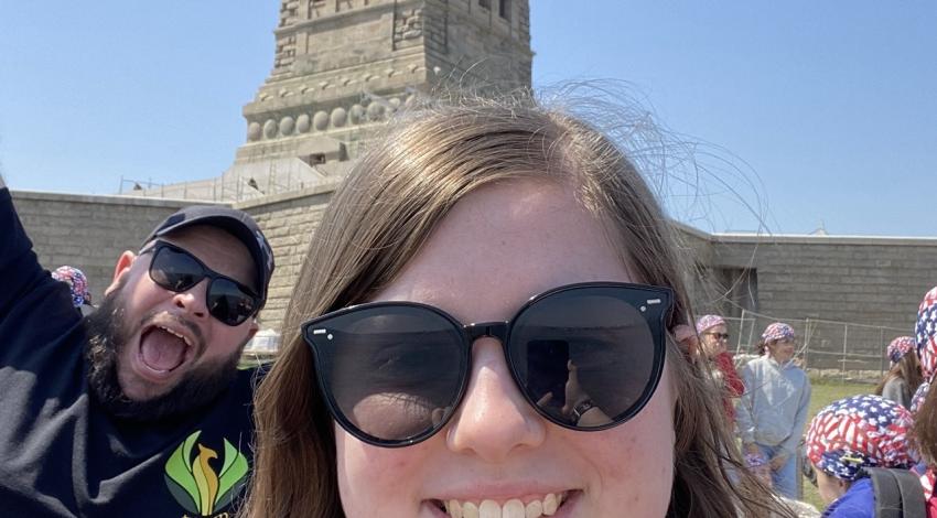 woman photobombed by man behind her