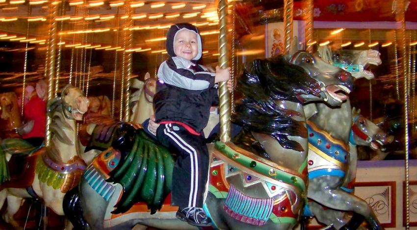 boy on carousel horse