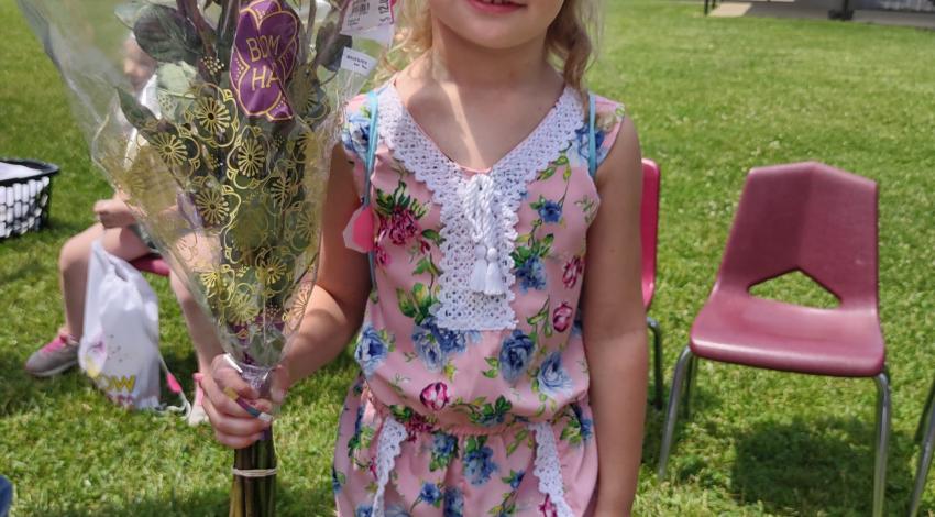 little girl holding flowers