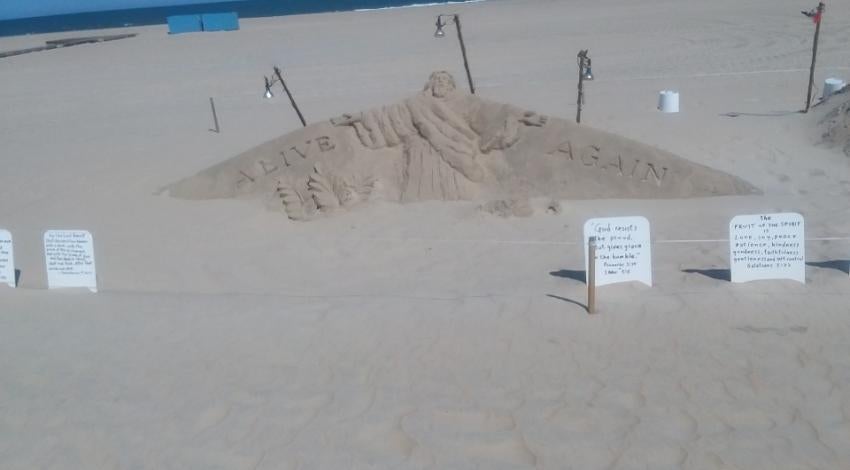 large sandcastle roped off on beach
