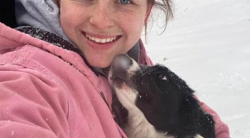 young woman and dog in snow