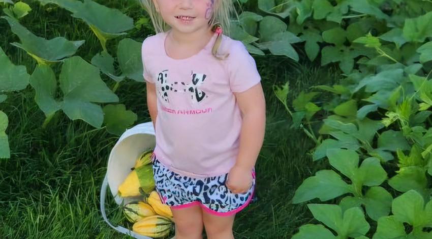 little girl with basket of gourds