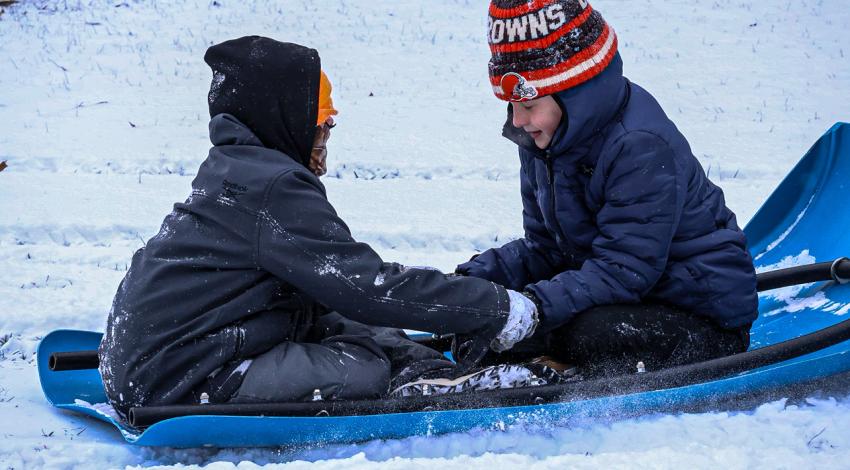 two kids on sled