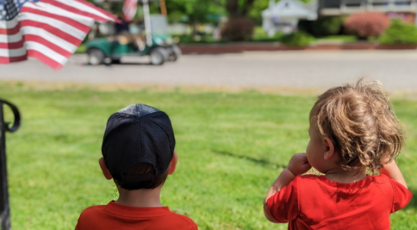 two little boys watching a parade