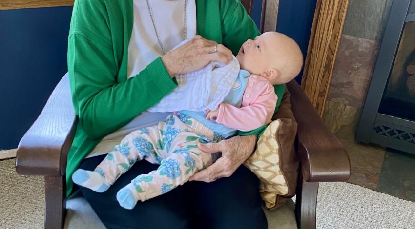 woman on rocking chair with tiny baby