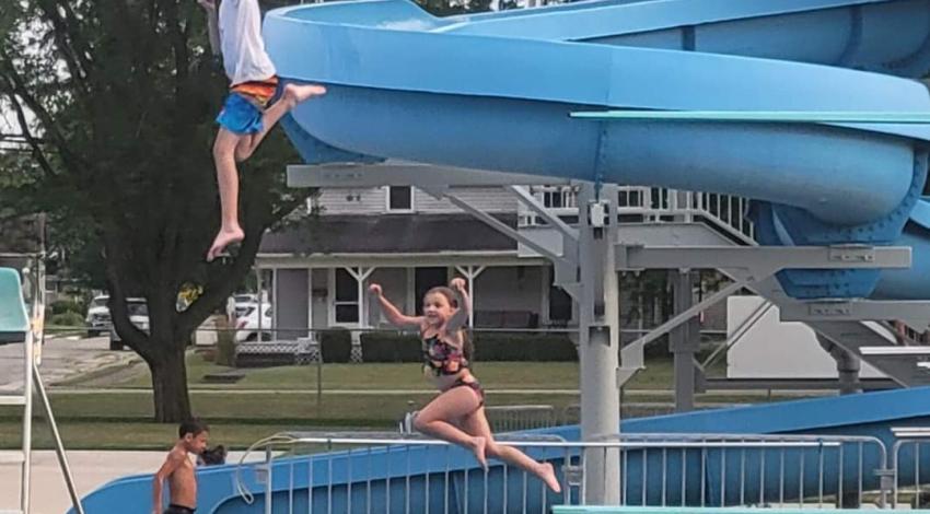 boy and girl jumping off diving boards