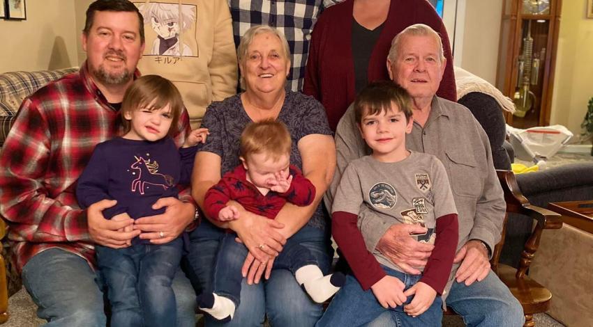 Adults and children pose in living room