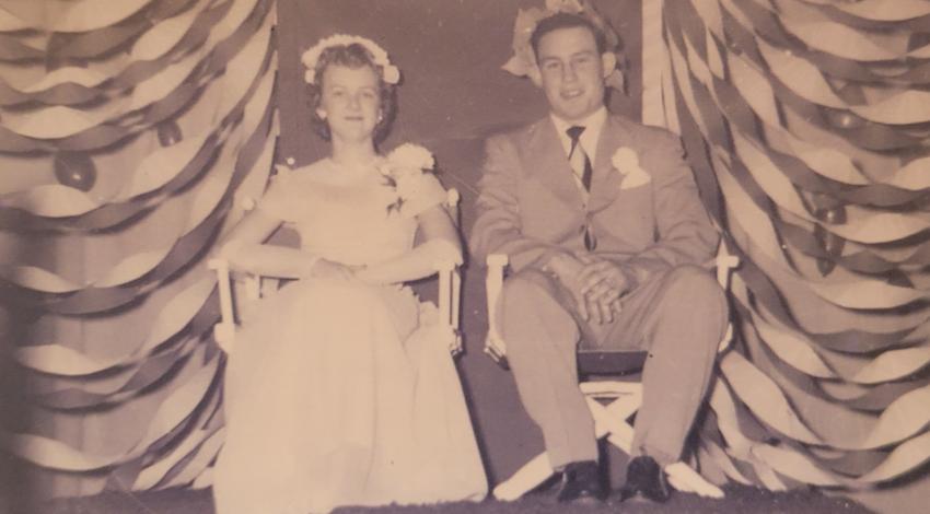 sepia photo of young man and young woman, dressed up
