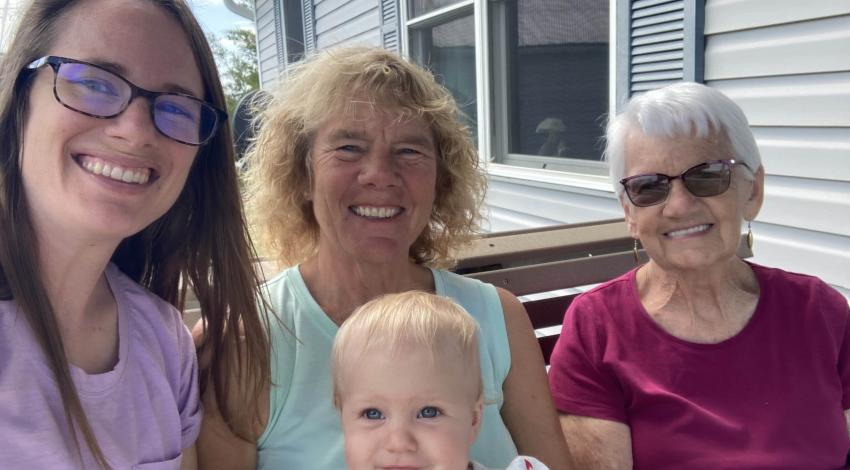 three women and a baby outside