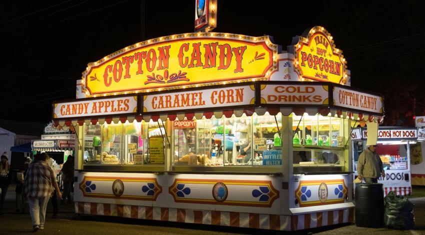 fair food stand advertising cotton candy, caramel corn, etc.