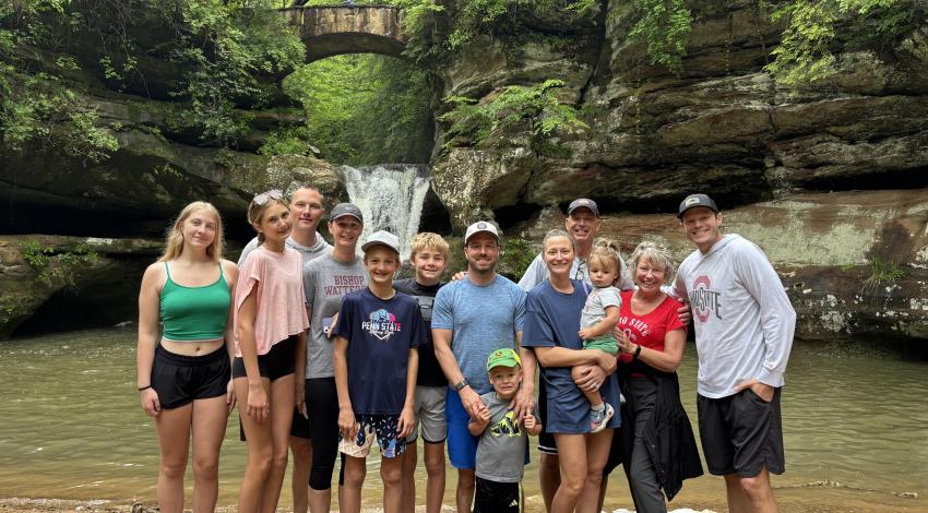 group of people in front of waterfall