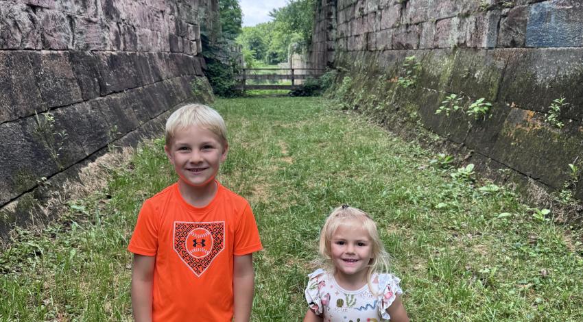 two children between stone walls