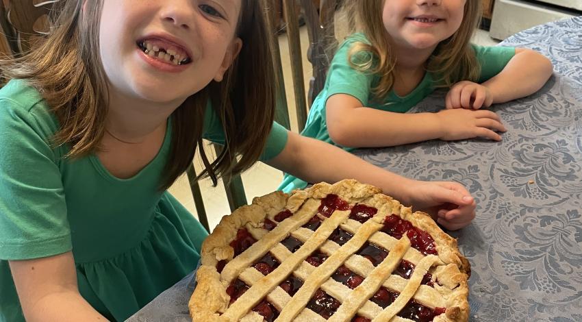 two little girls and a pie