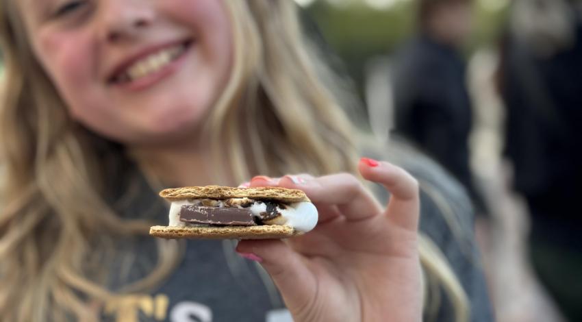smiling girl holding s'more