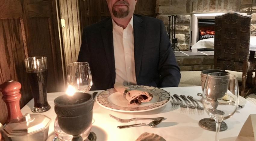 man at candlelit table