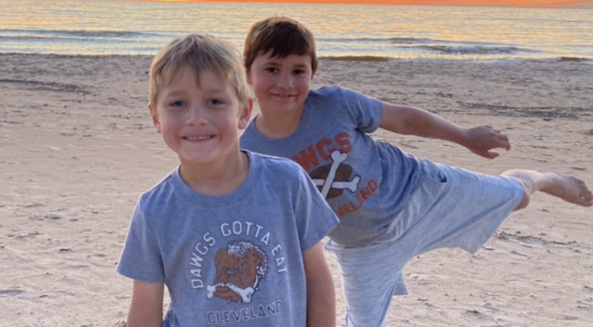 two boys on a sandy beach