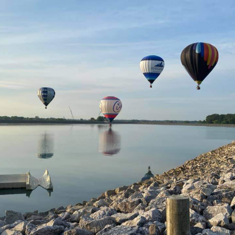 Hot air balloons fly over the up-ground reservoir in Marysville. Photo credit: Anne Dodge