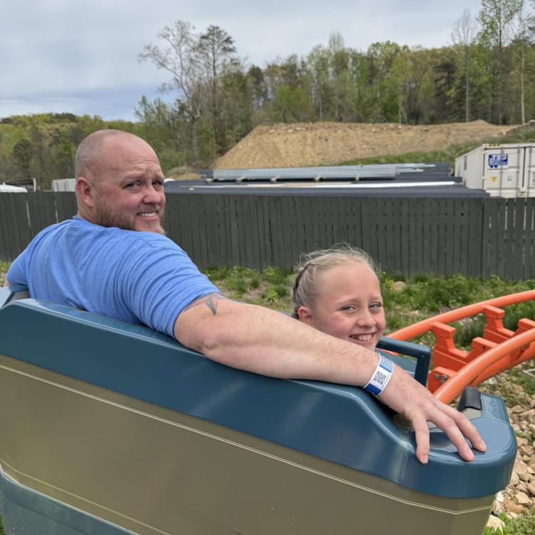 man and girl on roller coaster