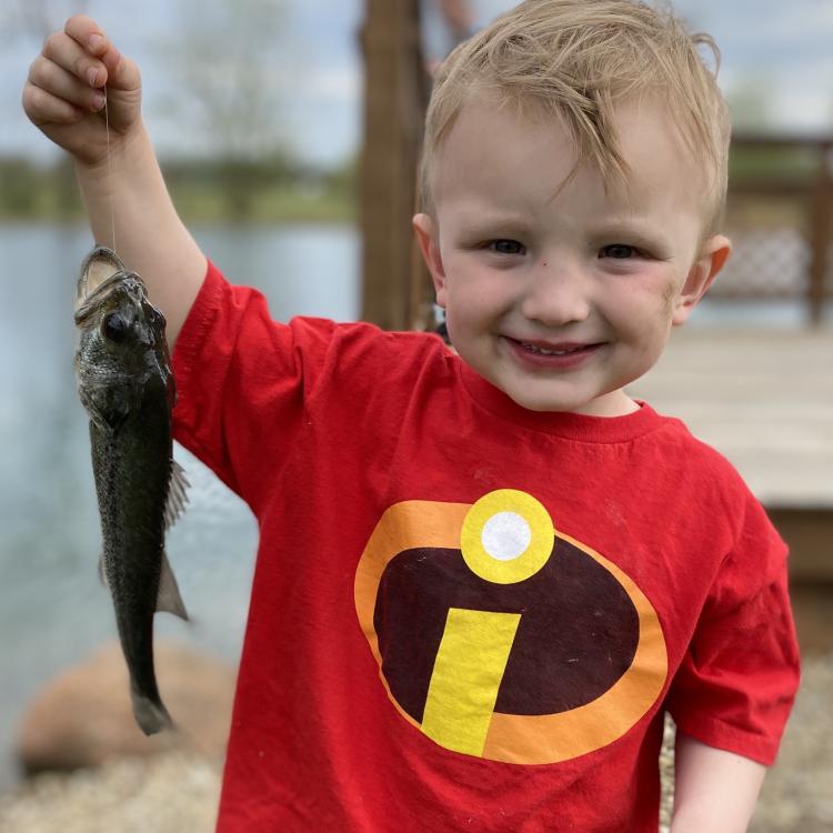 Little boy holding a fish