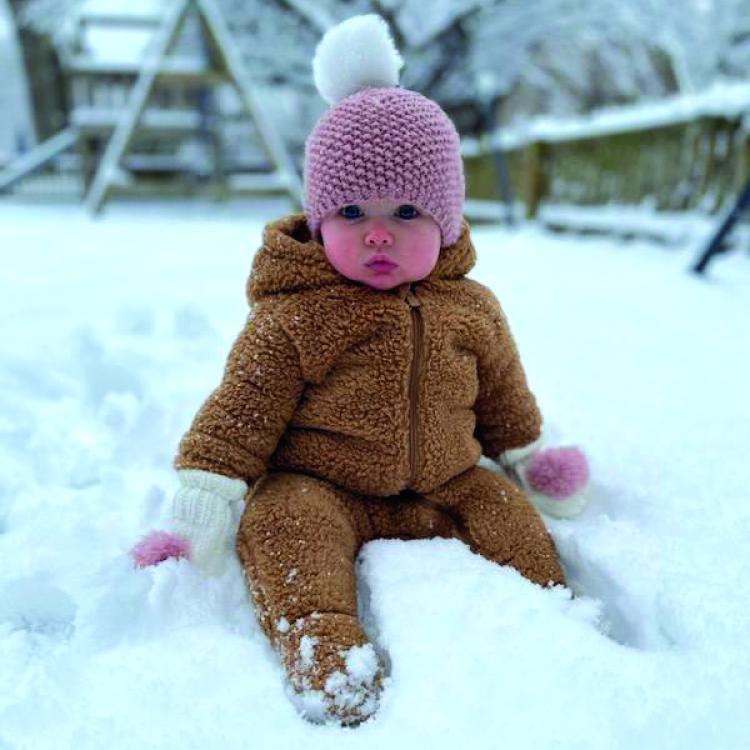 Baby sitting in snow