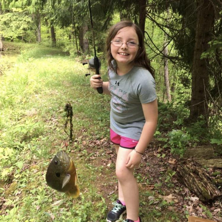 girl smiling holding fish