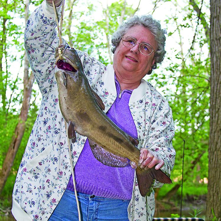 woman holding a large fish