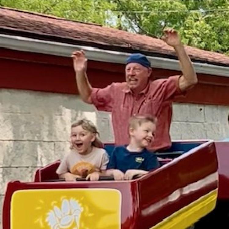 Man and two boys on roller coaster