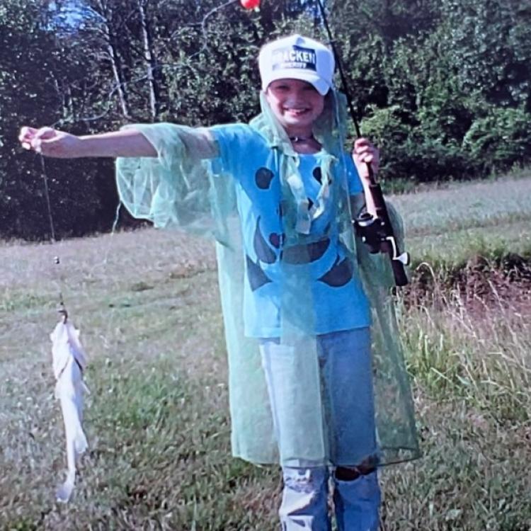 girl smiling holding fish