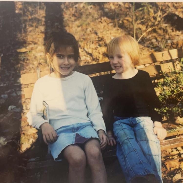 two little girls sitting on bench