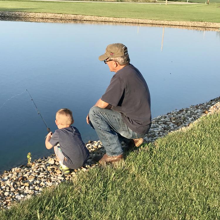 little boy and his grandpa fishing