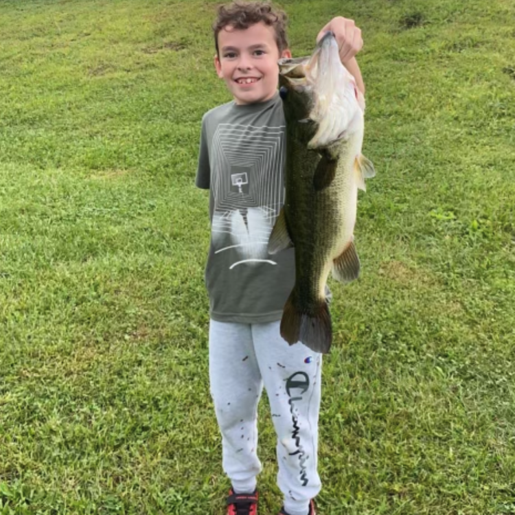 Boy smiling holding a fish