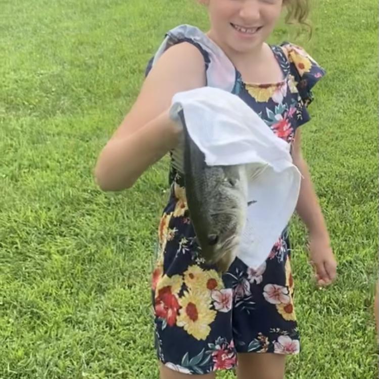 girl smiling holding a fish