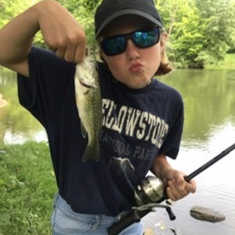 kid holding a fish