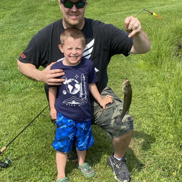 boy and his dad holding a fish