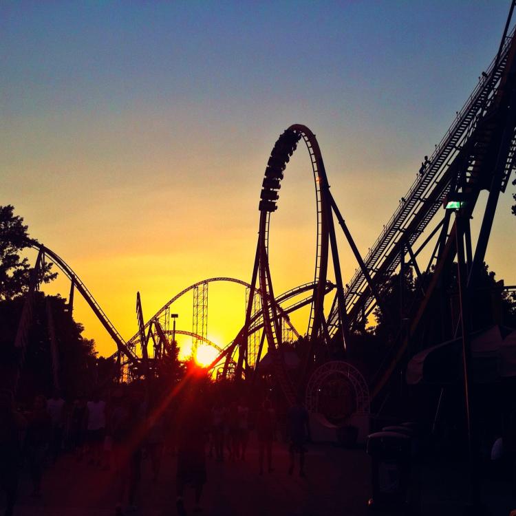 roller coasters in front of sunset