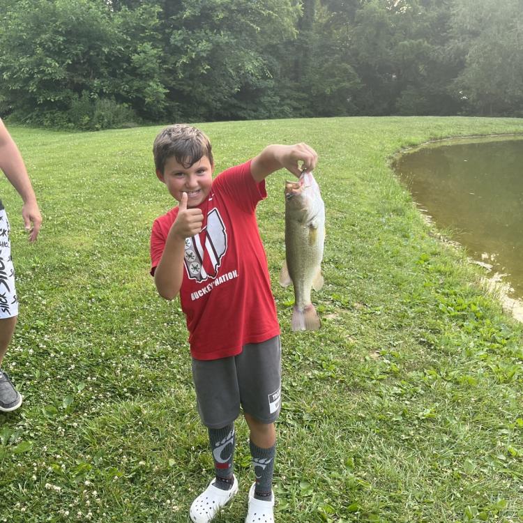 boy smiling holding a fish